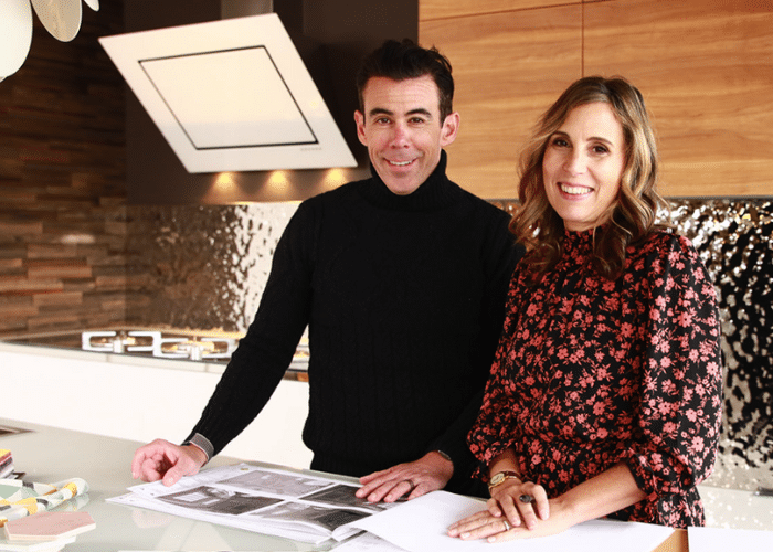 Anne and Kevin Capozzi designing a new kitchen on a crowded kitchen island.